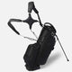 Black golf bag with stand on a white background