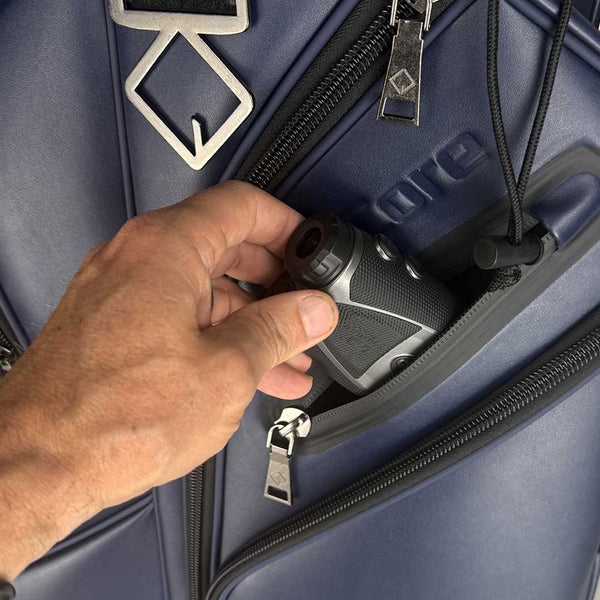 Hand opening a blue suitcase with a key fob
